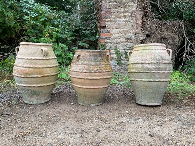 Lot 1306 - A group of three terracotta Pithoi type jars