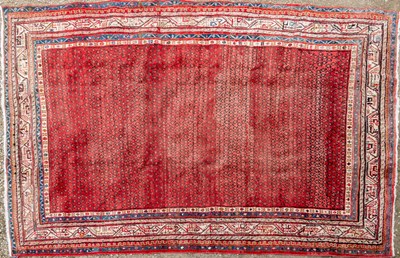 Lot 1056 - A red ground large Oriental rug