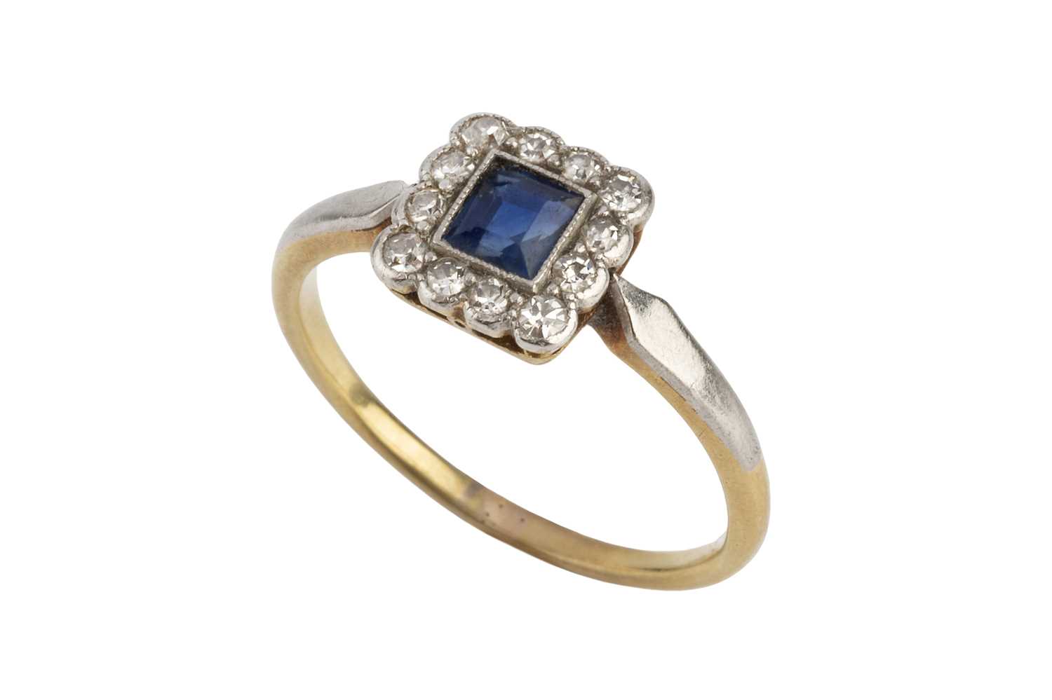 Lot 94 - A sapphire and diamond cluster ring, the...