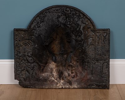 Lot 1297 - An antique cast iron fire back