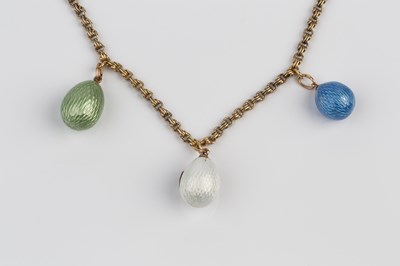 Lot 121 - Three Russian enamel egg pendants, the first...
