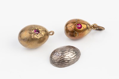 Lot 121 - Three Russian enamel egg pendants, the first...