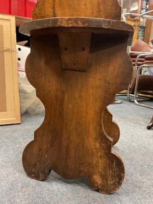 Lot 562 - A heavily carved Sgabello style Italian walnut hall chair