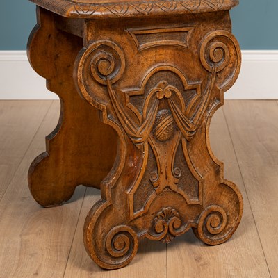 Lot 562 - A heavily carved Sgabello style Italian walnut hall chair