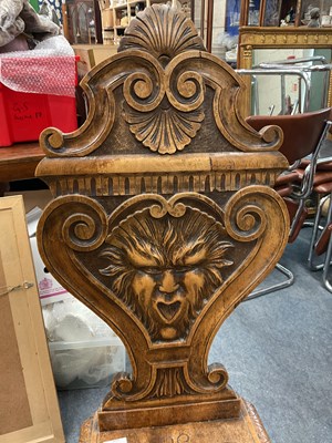 Lot 562 - A heavily carved Sgabello style Italian walnut hall chair