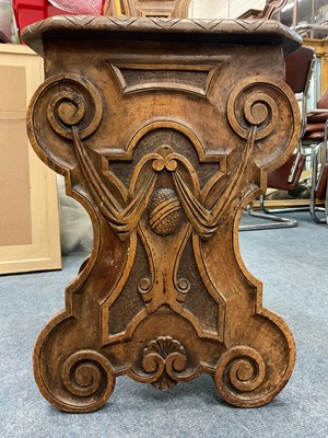 Lot 562 - A heavily carved Sgabello style Italian walnut hall chair