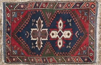 Lot 1071 - A small blue ground rug