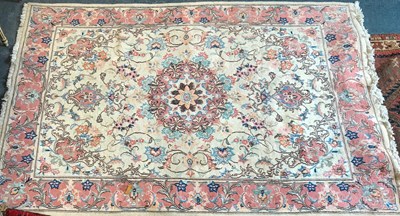 Lot 1075 - A cream ground Oriental rug