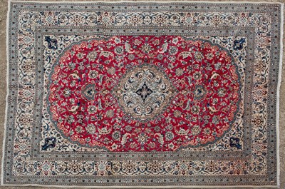 Lot 424 - A red ground Oriental rug