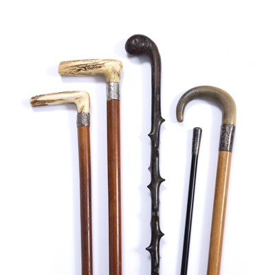 Lot 58 - Three antique malacca walking canes with white...