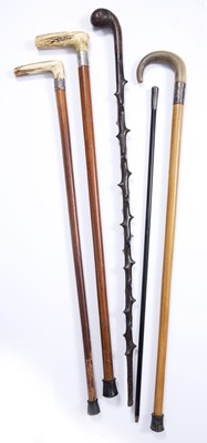 Lot 58 - Three antique malacca walking canes with white...