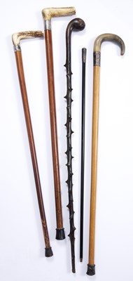 Lot 58 - Three antique malacca walking canes with white...