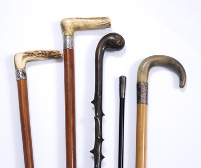 Lot 58 - Three antique malacca walking canes with white...