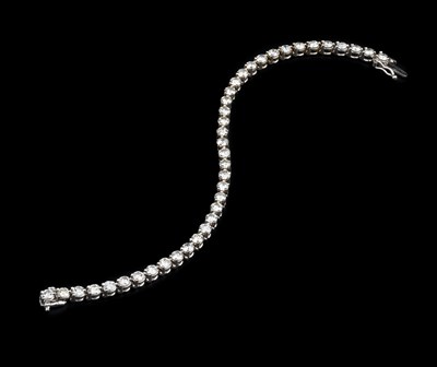 Lot 188 - A diamond line bracelet, the round...