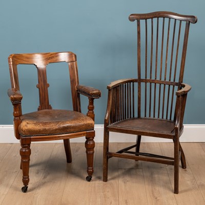 Lot 690 - A brown leather seated hardwood desk chair together with a stick back beechwood armchair