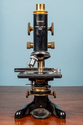 Lot 28 - A W Watson & Sons monocular microscope and an adjustable slide clamp by J Swift & Son London