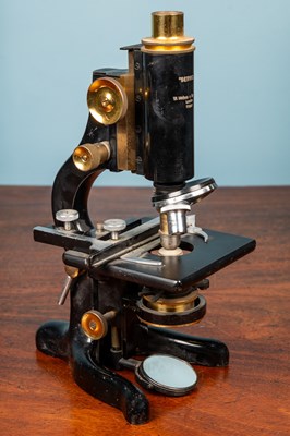 Lot 28 - A W Watson & Sons monocular microscope and an adjustable slide clamp by J Swift & Son London