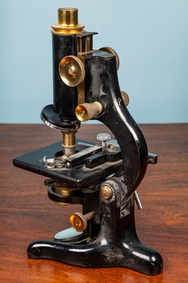 Lot 28 - A W Watson & Sons monocular microscope and an adjustable slide clamp by J Swift & Son London