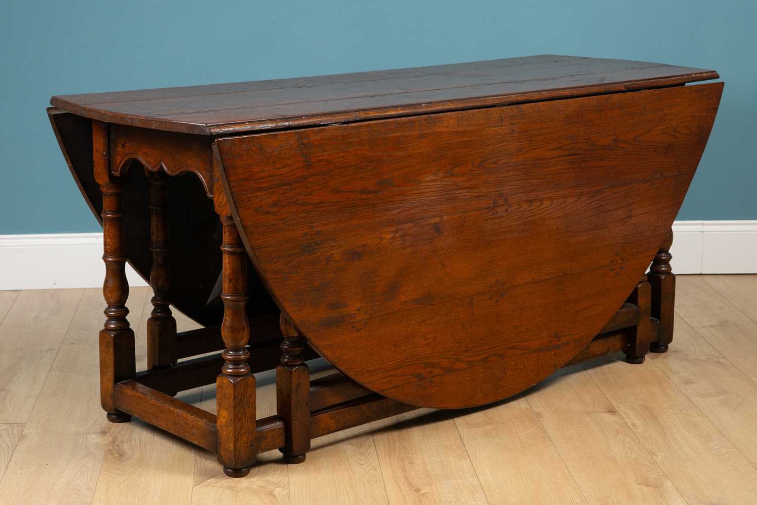 Lot 660 - A 19th century oak gate leg table