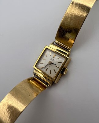 Lot 246 - A yellow precious metal bracelet watch, the...