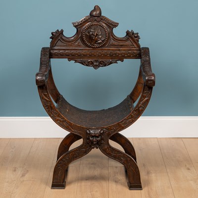 Lot 241 - An Italian carved walnut savanarola elbow chair