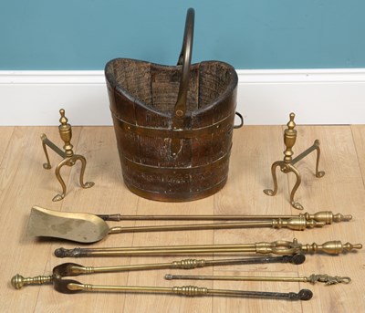 Lot 247 - A set of brass fire irons together with two fire dogs and a brass bound bucket