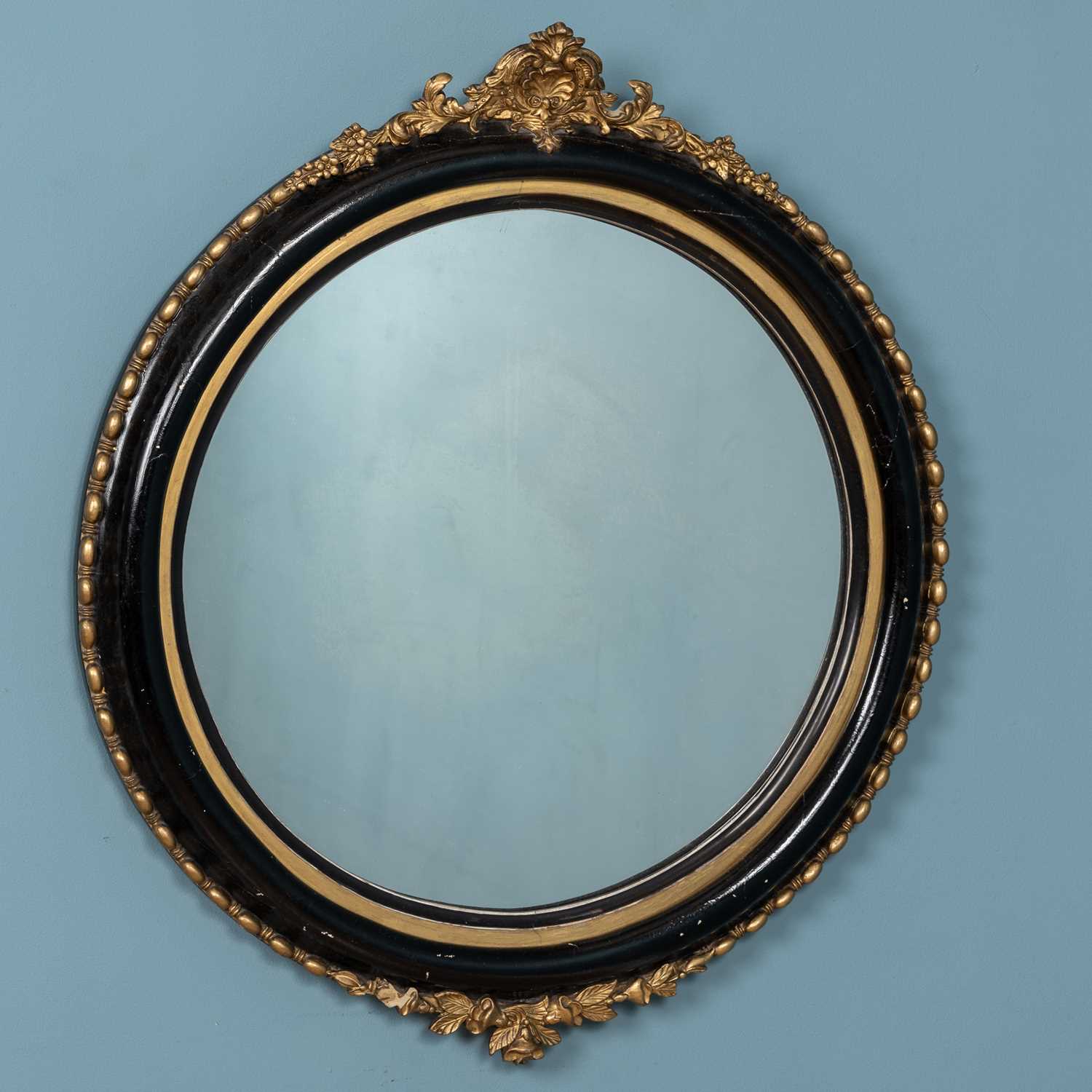 Lot 681 - A circular wall mirror