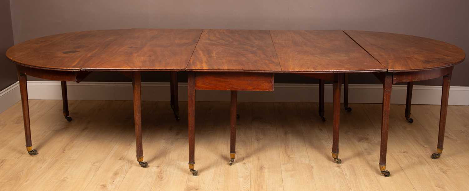 Lot 63 - A George III extending D-end dining table