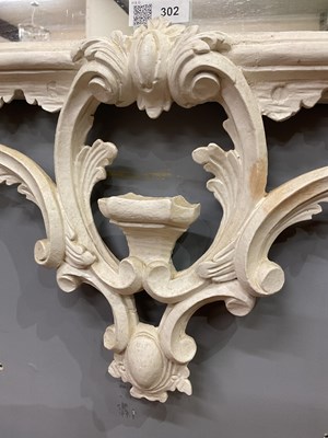 Lot 302 - A Georgian style white painted Rococo wall mirror