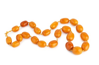 Lot 287 - An amber bead necklace, the continuous single...