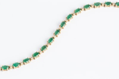 Lot 120 - An emerald and diamond line bracelet, designed...