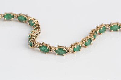 Lot 120 - An emerald and diamond line bracelet, designed...