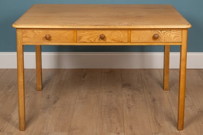 Lot 143 - A pine veneered kitchen table with three...