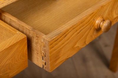 Lot 143 - A pine veneered kitchen table with three...