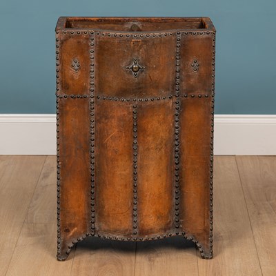 Lot 308 - A leather and brass hammered umbrella stand