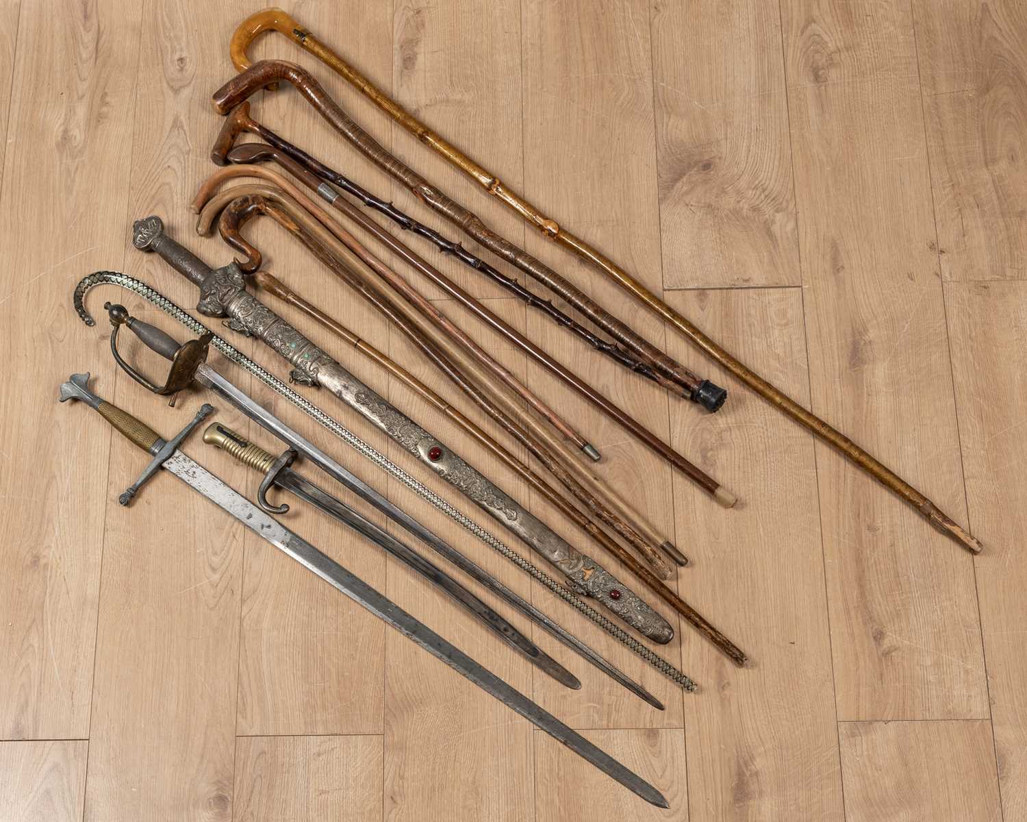 Lot 83 - A collection of walking sticks and militaria