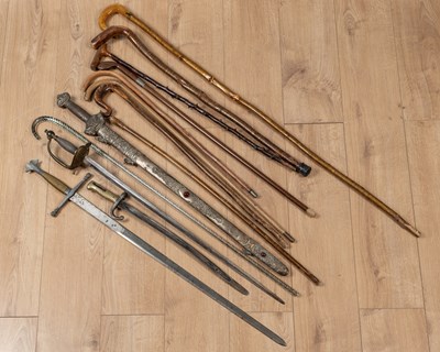 Lot 83 - A collection of walking sticks and militaria