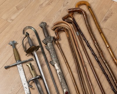Lot 83 - A collection of walking sticks and militaria