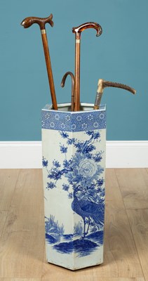 Lot 367 - A porcelain umbrella stand together with two walking sticks, one cane and a riding crop