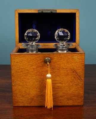 Lot 412 - A Victorian oak decanter case and two cut class decanters