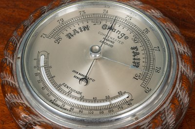 Lot 64 - A compensated marine aneroid barometer together with an Arts & Crafts mahogany adjustable book slide
