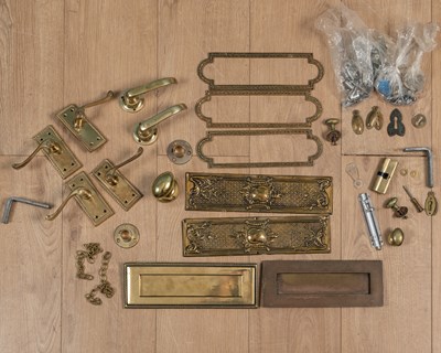 Lot 357 - A collection of brass letterbox flaps, door handles and lockplates