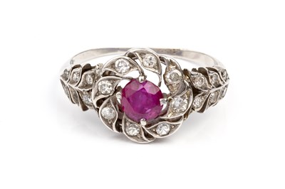 Lot 118 - A ruby and diamond cluster ring, the circular...