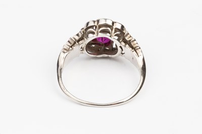 Lot 118 - A ruby and diamond cluster ring, the circular...