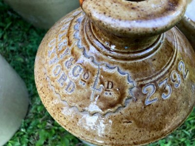 Lot 667 - A group of seven stoneware bottle and jars of local interest