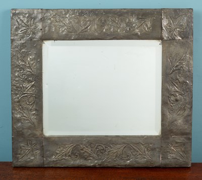 Lot 418 - A mirror with a hammered metal frame decorated with ivy leaf motif