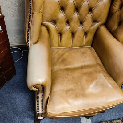 Lot 40 - A pair of Regency style leather wingback armchairs together with three stools