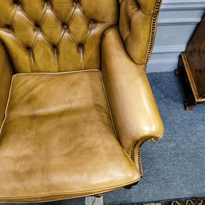 Lot 40 - A pair of Regency style leather wingback armchairs together with three stools