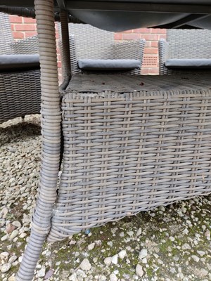 Lot 575 - An oval glass topped garden table together with a set of eight faux wicker chairs