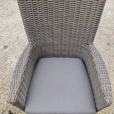 Lot 575 - An oval glass topped garden table together with a set of eight faux wicker chairs
